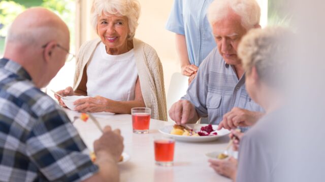 Pensioners eating lunch